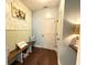 Hallway with wood floors, bench seating, decorative wallpaper, and access to rooms at 8340 Nolandwood Ln, Villa Rica, GA 30180