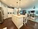 Bright open kitchen with a large island, pendant lighting, and views into living area at 8340 Nolandwood Ln, Villa Rica, GA 30180