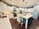 Well lit kitchen offering stainless appliances, white cabinets and center island with seating at 8340 Nolandwood Ln, Villa Rica, GA 30180