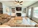 Bright living room featuring a fireplace, built-in shelves, and hardwood floors at 8340 Nolandwood Ln, Villa Rica, GA 30180