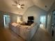 Comfortable living room featuring a vaulted ceiling, ceiling fan, and a large sectional sofa at 8340 Nolandwood Ln, Villa Rica, GA 30180