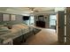 Spacious primary bedroom with a large bed, dark wood dresser, neutral walls, and plenty of natural light at 8340 Nolandwood Ln, Villa Rica, GA 30180
