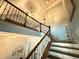 Open staircase with dark wood railing and floors and high ceilings at 8340 Nolandwood Ln, Villa Rica, GA 30180