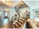 Open staircase with dark wood railing and floors connecting to the foyer at 8340 Nolandwood Ln, Villa Rica, GA 30180