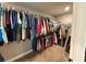 Walk-in closet with hanging clothes, ensuring ample storage space at 8340 Nolandwood Ln, Villa Rica, GA 30180