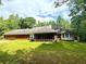 Home's rear exterior view showing a screened porch and a large, grassy yard at 8872 Conners Rd, Villa Rica, GA 30180