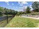 A sprawling backyard features a serene in-ground pool and lake views beyond the property line at 1408 Chloe Dr, Lawrenceville, GA 30043