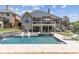The home's backyard features a lovely in-ground pool and an elevated patio with an outdoor dining area at 1408 Chloe Dr, Lawrenceville, GA 30043