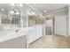 Bright bathroom with double sinks, large mirror, and glass enclosed shower at 1408 Chloe Dr, Lawrenceville, GA 30043