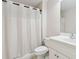 Clean bathroom with a white vanity, toilet, shower, and a neutral color palette at 1408 Chloe Dr, Lawrenceville, GA 30043