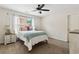Bright bedroom with a ceiling fan, neutral walls, carpeted floor, and natural light at 1408 Chloe Dr, Lawrenceville, GA 30043