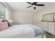 Charming bedroom featuring a ceiling fan, dresser, natural light, and a soft color palette at 1408 Chloe Dr, Lawrenceville, GA 30043