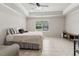 Bedroom featuring large window, tile flooring, tray ceiling, and ceiling fan at 1408 Chloe Dr, Lawrenceville, GA 30043