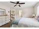 Inviting bedroom featuring neutral colors, a ceiling fan, natural light, and carpeted floor at 1408 Chloe Dr, Lawrenceville, GA 30043