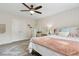 Cozy bedroom with a ceiling fan, carpet and rug, complimented by matching furniture and light-colored walls at 1408 Chloe Dr, Lawrenceville, GA 30043