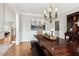 Formal dining room featuring hardwood floors, wainscoting, and chandelier at 1408 Chloe Dr, Lawrenceville, GA 30043