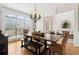 Elegant dining room with hardwood floors, a large window, and stylish chandelier at 1408 Chloe Dr, Lawrenceville, GA 30043
