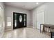 Inviting foyer area with tile flooring, black front door, and adjacent seating area at 1408 Chloe Dr, Lawrenceville, GA 30043