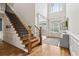 Bright and airy foyer featuring hardwood floors, staircase, and transom window at 1408 Chloe Dr, Lawrenceville, GA 30043