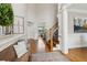 Welcoming foyer with hardwood floors, bench, and staircase at 1408 Chloe Dr, Lawrenceville, GA 30043