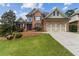 Charming brick two-story home with manicured lawn and beautiful landscaping at 1408 Chloe Dr, Lawrenceville, GA 30043