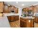 Gourmet kitchen featuring wood cabinets, a kitchen island, and stainless steel appliances at 1408 Chloe Dr, Lawrenceville, GA 30043