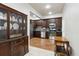 A well-appointed kitchen with stainless steel appliances, dark cabinets, tile backsplash and wood floors at 1408 Chloe Dr, Lawrenceville, GA 30043