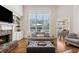 Beautifully lit living room featuring hardwood floors, a fireplace, and built-in shelves at 1408 Chloe Dr, Lawrenceville, GA 30043