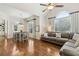 Bright living area adjacent to dining space, features large windows and hardwood floors at 1408 Chloe Dr, Lawrenceville, GA 30043