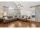 Inviting living room with plush seating, a ceiling fan, and large windows with blinds at 1408 Chloe Dr, Lawrenceville, GA 30043