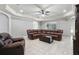 Spacious living area with tile floors, a leather sectional sofa and cozy chair, under a trey ceiling with recessed lights at 1408 Chloe Dr, Lawrenceville, GA 30043