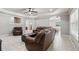 Bright living room with tile floors, a coffered ceiling, and a leather sectional sofa at 1408 Chloe Dr, Lawrenceville, GA 30043