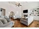 Open living room with fireplace, hardwood floors, and a view into other rooms at 1408 Chloe Dr, Lawrenceville, GA 30043