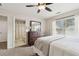 Comfortable main bedroom featuring a ceiling fan, natural light, and adjoining bathroom at 1408 Chloe Dr, Lawrenceville, GA 30043