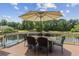 Outdoor patio space with table, chairs and umbrella overlooking lush backyard at 1408 Chloe Dr, Lawrenceville, GA 30043