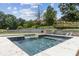 An in-ground pool boasts a spa area with an integrated waterfall feature at 1408 Chloe Dr, Lawrenceville, GA 30043