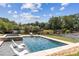 A beautiful backyard pool featuring lounge chairs, a spa, and lush landscaping at 1408 Chloe Dr, Lawrenceville, GA 30043
