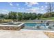 This pool boasts a spa area, a waterfall feature, and stylish in-pool lounge chairs at 1408 Chloe Dr, Lawrenceville, GA 30043