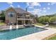 The backyard features an in-ground pool and hot tub with lush landscaping at 1408 Chloe Dr, Lawrenceville, GA 30043