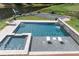 Aerial view of private pool, hot tub and deck overlooking manicured lawn at 1408 Chloe Dr, Lawrenceville, GA 30043