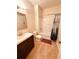 Bathroom with wooden floors, vanity, toilet, and tub/shower at 4438 Lassen Ct, Suwanee, GA 30024