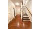 Bright foyer with hardwood floors, staircase, and white trim at 4438 Lassen Ct, Suwanee, GA 30024