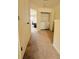 Upstairs hallway featuring a laundry closet and a glimpse into a room with a desk at 4438 Lassen Ct, Suwanee, GA 30024