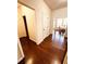 Inviting hallway with hardwood floors leading to a bright dining area at 4438 Lassen Ct, Suwanee, GA 30024
