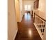 Hallway featuring hardwood floors leading to dining area at 4438 Lassen Ct, Suwanee, GA 30024