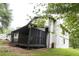 The backyard features a large, covered patio, mature trees and an expansive grassy area at 69 N Hearn Rd, Ellenwood, GA 30294