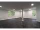Spacious basement with windows and dark, marble-look flooring at 69 N Hearn Rd, Ellenwood, GA 30294
