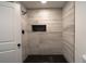 Modern bathroom featuring a stand-up shower and dark hexagon tile at 69 N Hearn Rd, Ellenwood, GA 30294