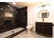 Contemporary bathroom featuring a dark marble shower, modern vanity, and round mirror at 69 N Hearn Rd, Ellenwood, GA 30294
