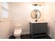Bathroom features a modern vanity, round mirror, and stylish light fixture at 69 N Hearn Rd, Ellenwood, GA 30294